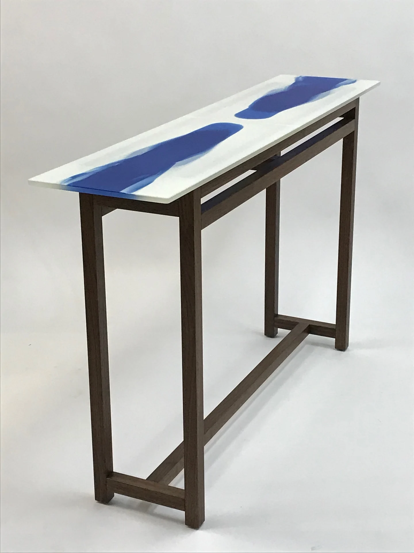Blue-and-white glass surface on an angular dark table frame
